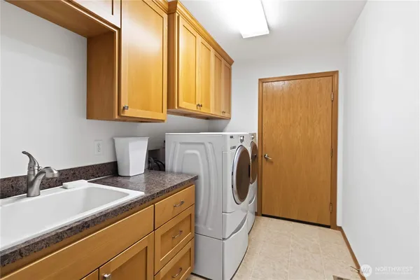a view of a storage and utility room with washer and dryer