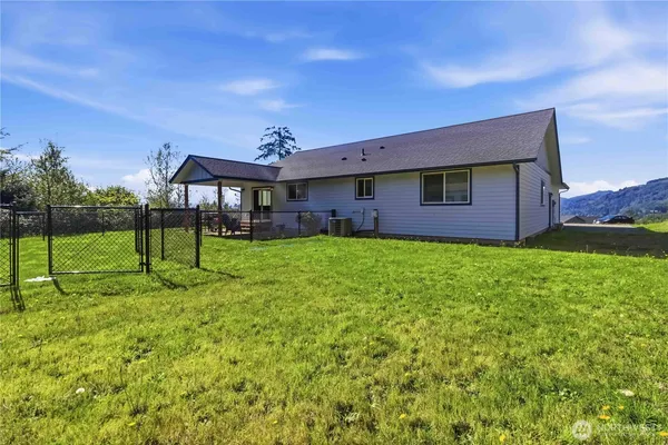 a view of a house with a yard and sitting area