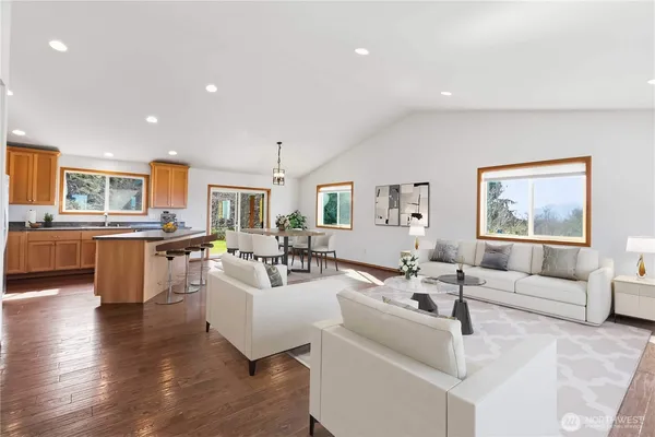 a living room with fireplace furniture and wooden floor