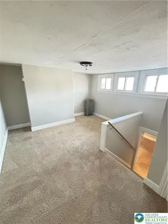 an empty room with windows and entrance