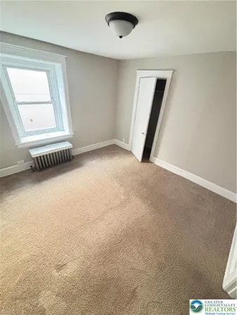 a view of an empty room with a window