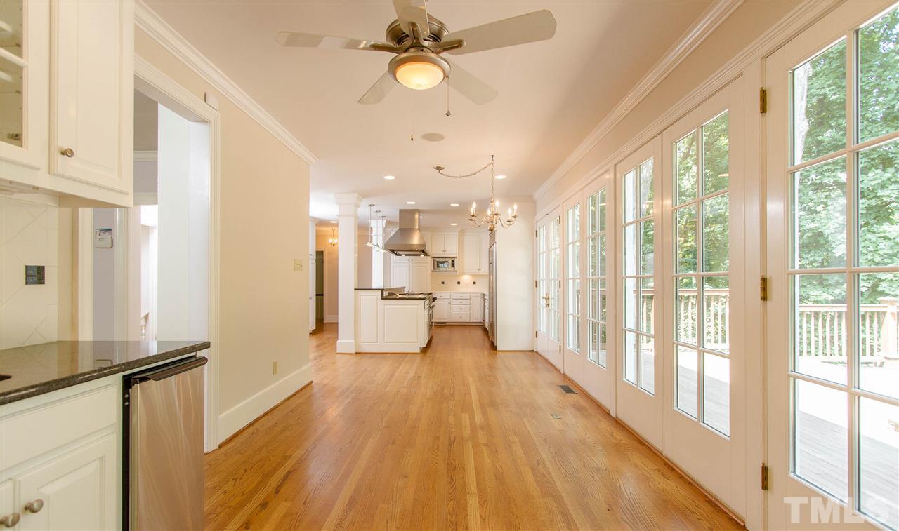 2726 Cambridge Road Raleigh, NC 27608 - Photo 8 of 25 a view of a kitchen with wooden floor and a kitchen space