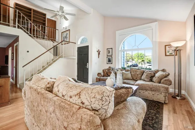 a living room with furniture window and wooden floor