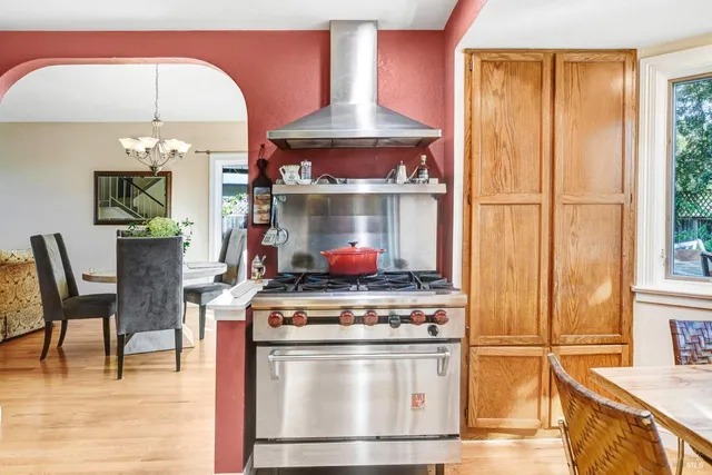 a stove top oven sitting inside of a kitchen