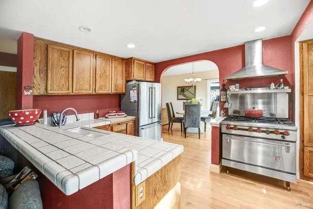 a kitchen with a stove a refrigerator and a dining table