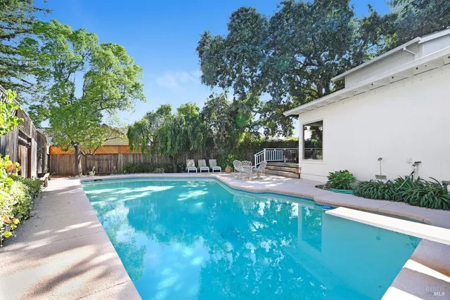 a view of backyard of house with green space