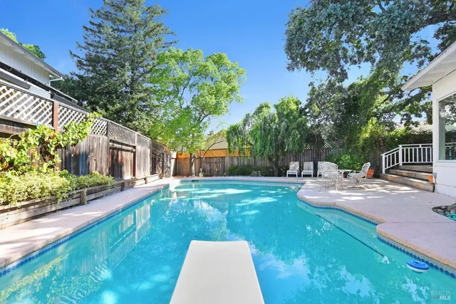 a view of a house with backyard and sitting area