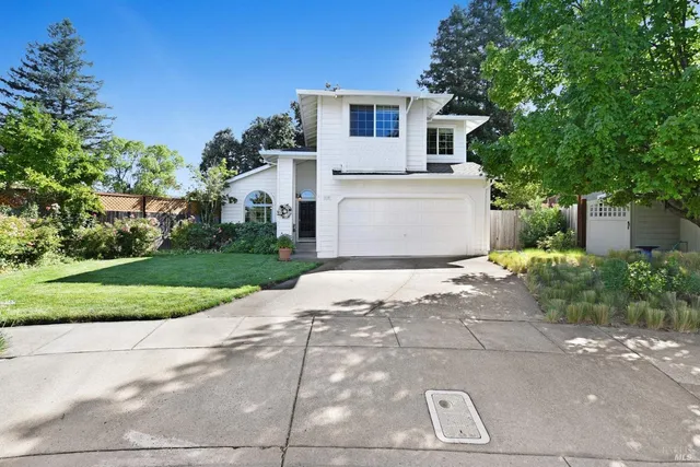 a view of a white house with a yard