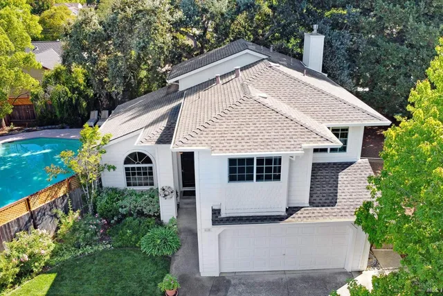 a front view of house with a garden