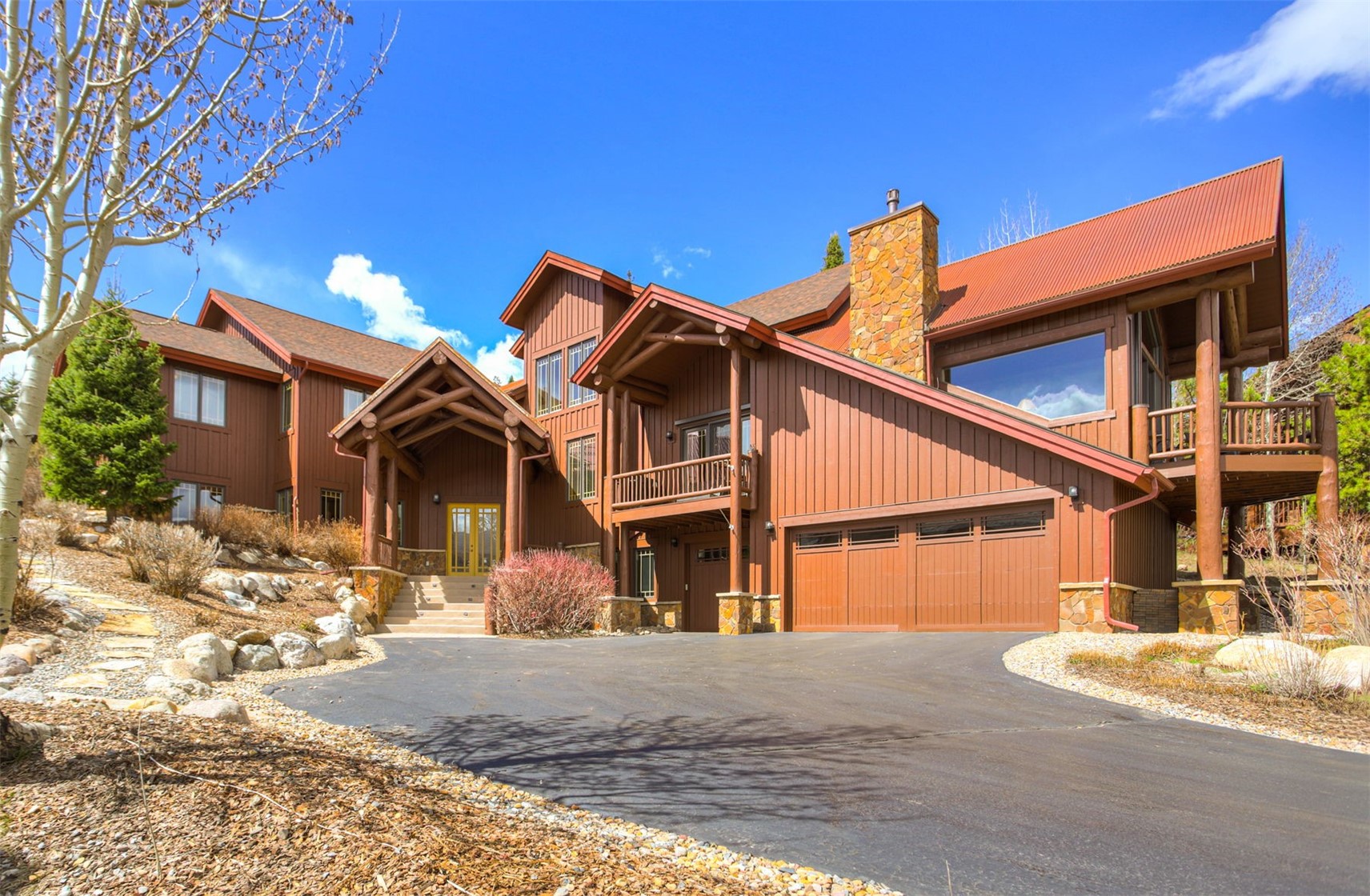 727 Willowbrook Road Silverthorne, CO 80498 - Photo 2 of 47 View of front of home with french doors, a balcony, a chimney, asphalt driveway, and an attached garage