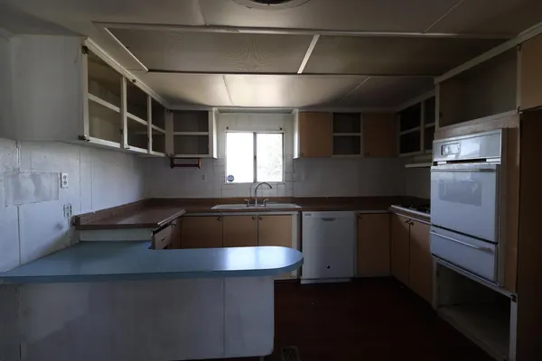 a kitchen with a sink cabinets and window
