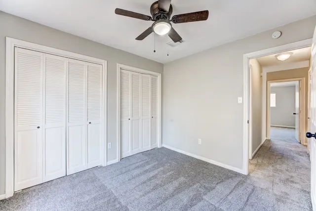a view of a chandelier fan and closet area
