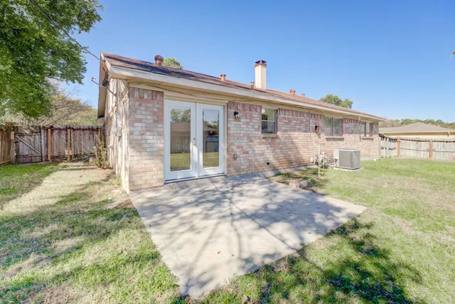 a view of a house with backyard and sitting area