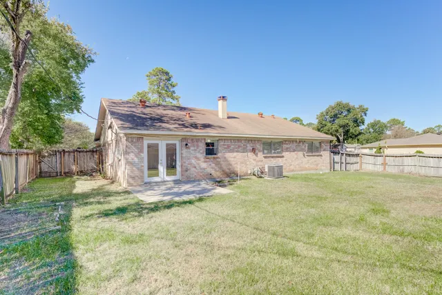 a view of a house with a yard and sitting area