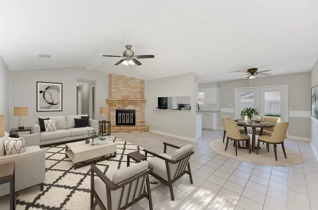 a living room with furniture a fireplace and a table