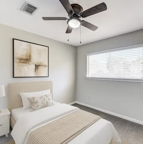 a bedroom with a large bed and a window