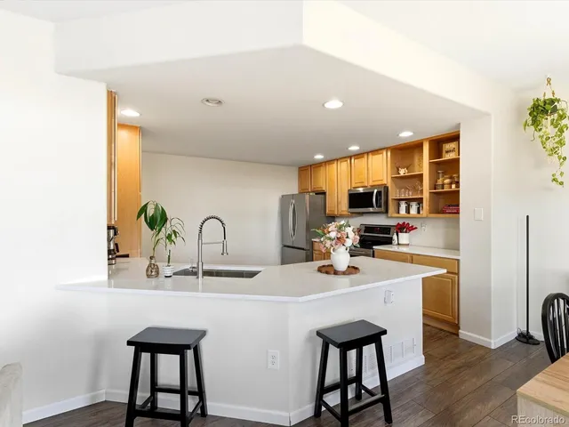 a kitchen with stainless steel appliances a sink and cabinets