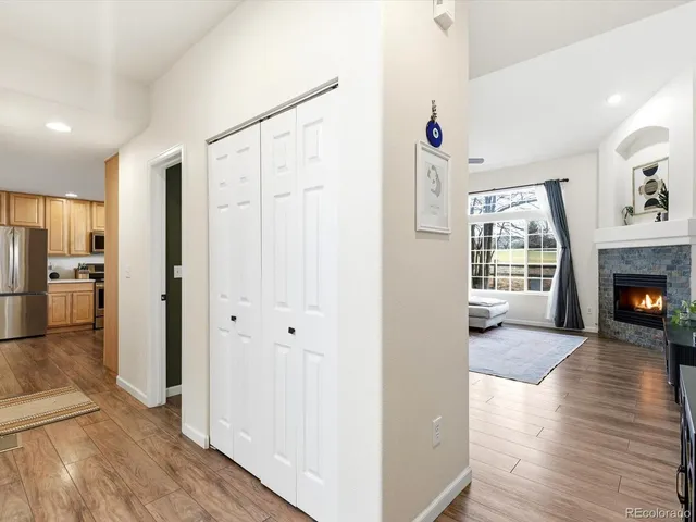 a view of a hallway with wooden floor and a fireplace