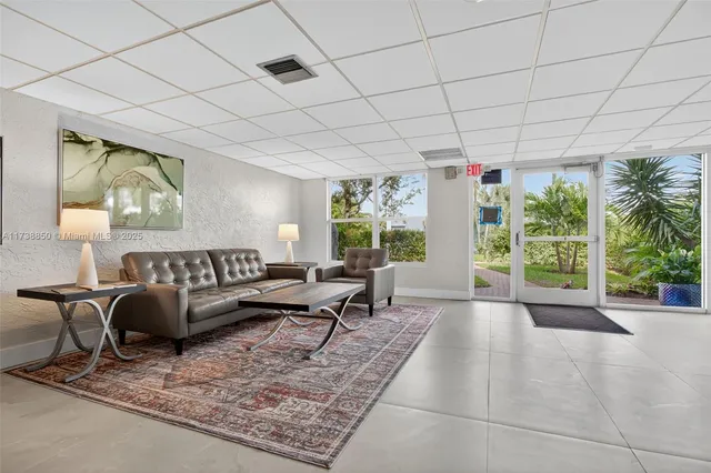a living room with furniture and large windows