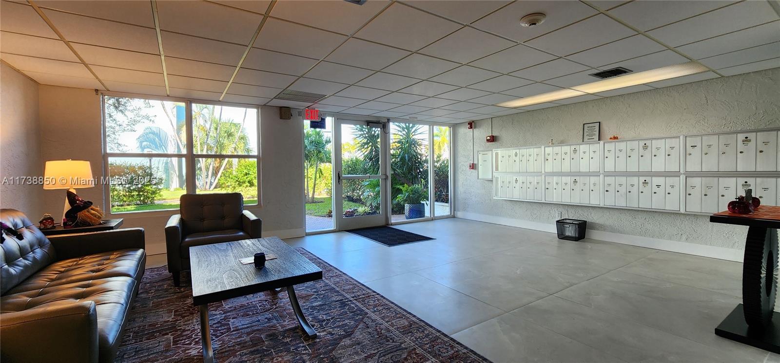 3004 Northeast 5th Terrace, Unit 214C Wilton Manors, FL 33334 - Photo 13 of 99 a living room with furniture and large windows