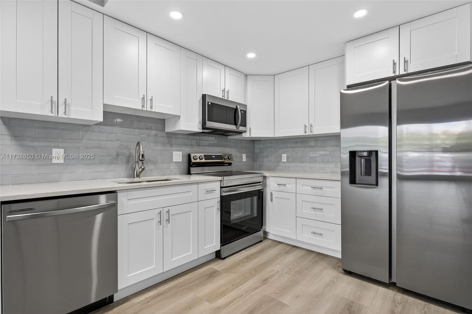 3004 Northeast 5th Terrace, Unit 214C Wilton Manors, FL 33334 - Photo 15 of 99 a kitchen with cabinets stainless steel appliances and a counter space