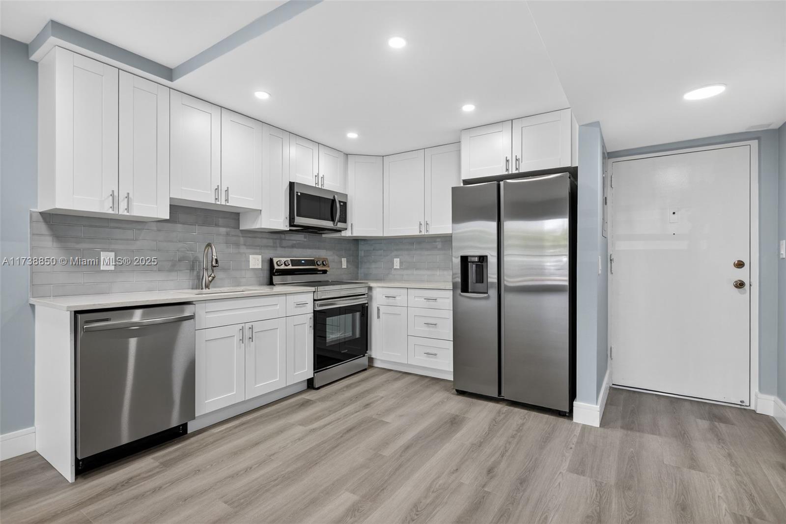 3004 Northeast 5th Terrace, Unit 214C Wilton Manors, FL 33334 - Photo 16 of 99 a kitchen with a refrigerator sink and microwave