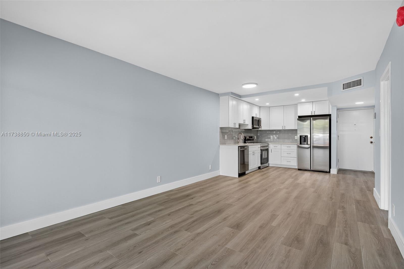 3004 Northeast 5th Terrace, Unit 214C Wilton Manors, FL 33334 - Photo 30 of 99 Living room view to kitchen