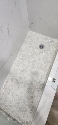 a view of a chair and table in backyard of the house