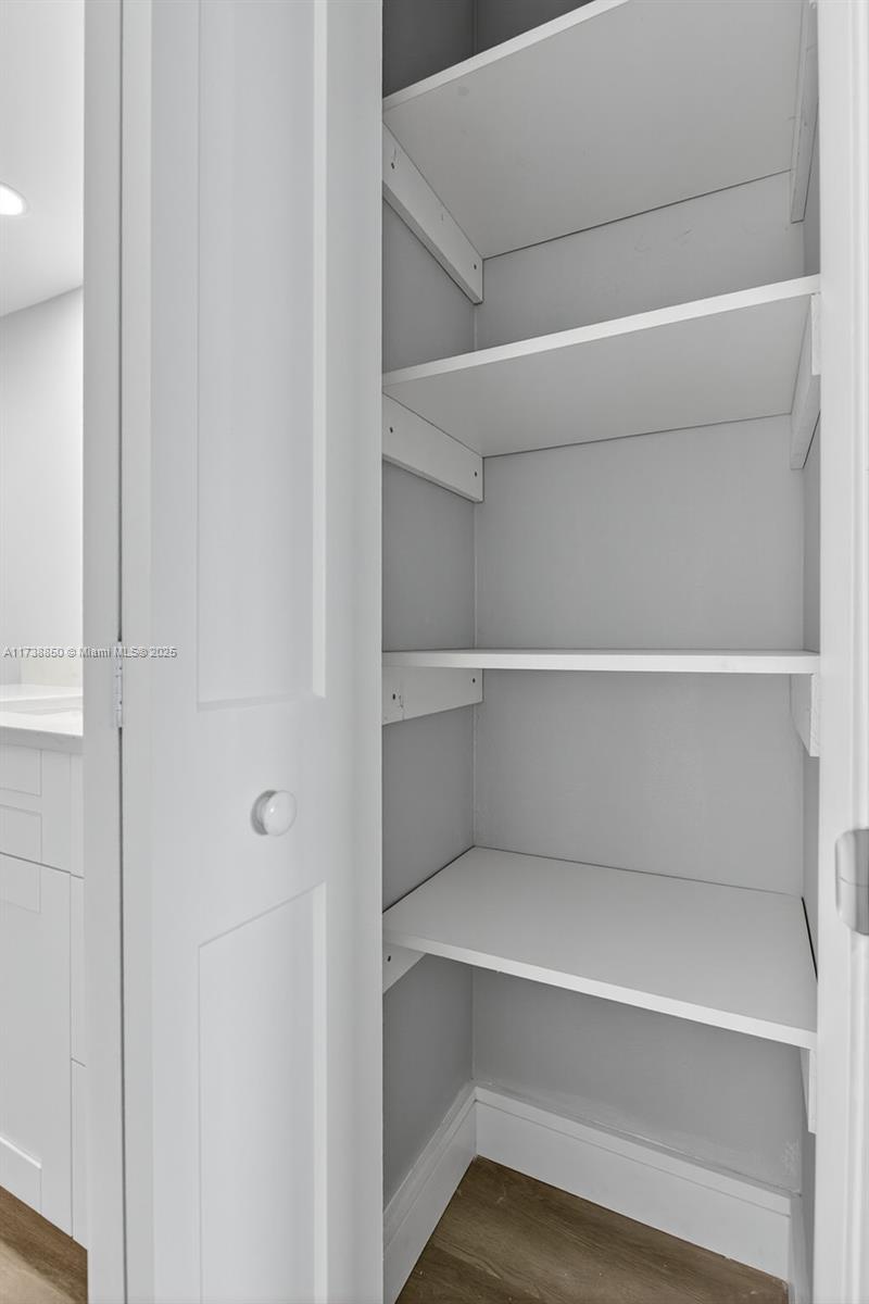 3004 Northeast 5th Terrace, Unit 214C Wilton Manors, FL 33334 - Photo 36 of 99 a view of walk in closet with empty racks