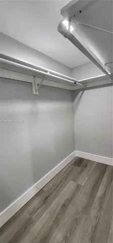 a kitchen with refrigerator and table