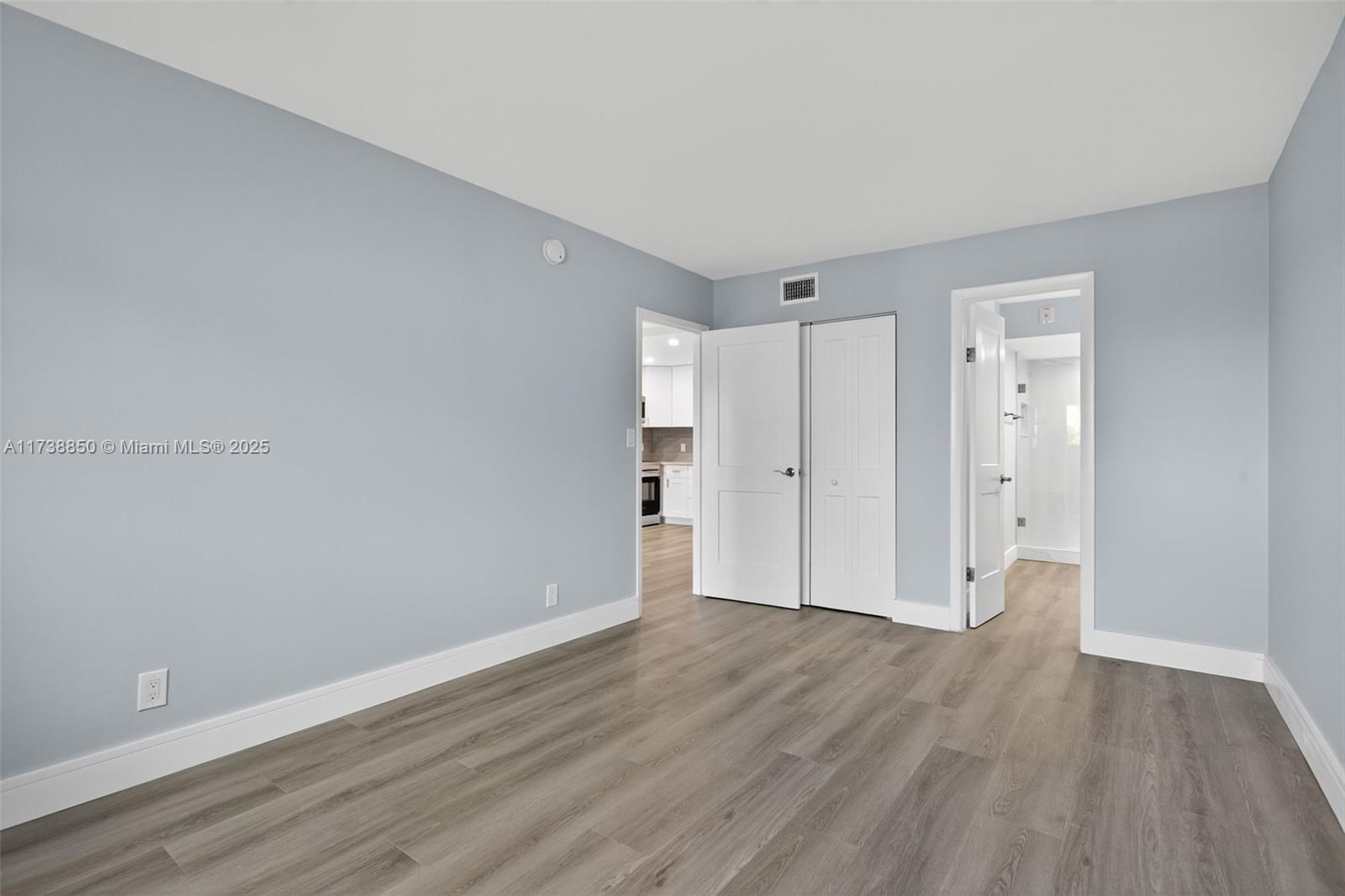 3004 Northeast 5th Terrace, Unit 214C Wilton Manors, FL 33334 - Photo 40 of 99 a view of an empty room with wooden floor