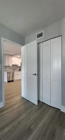 a view of a patio with table and chairs under an umbrella