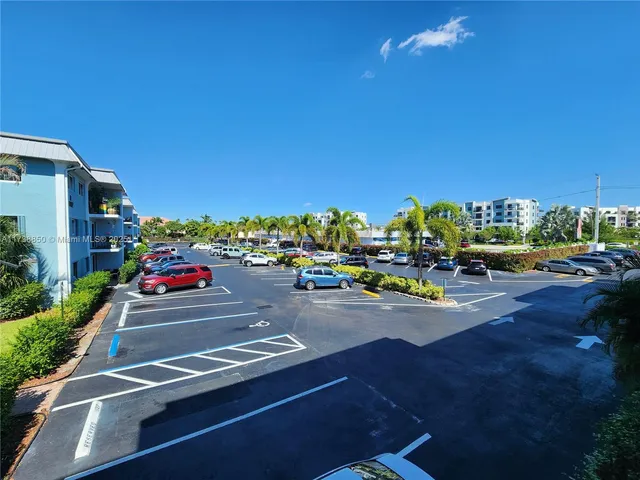 a view of a chair and table in the patio with a lake view