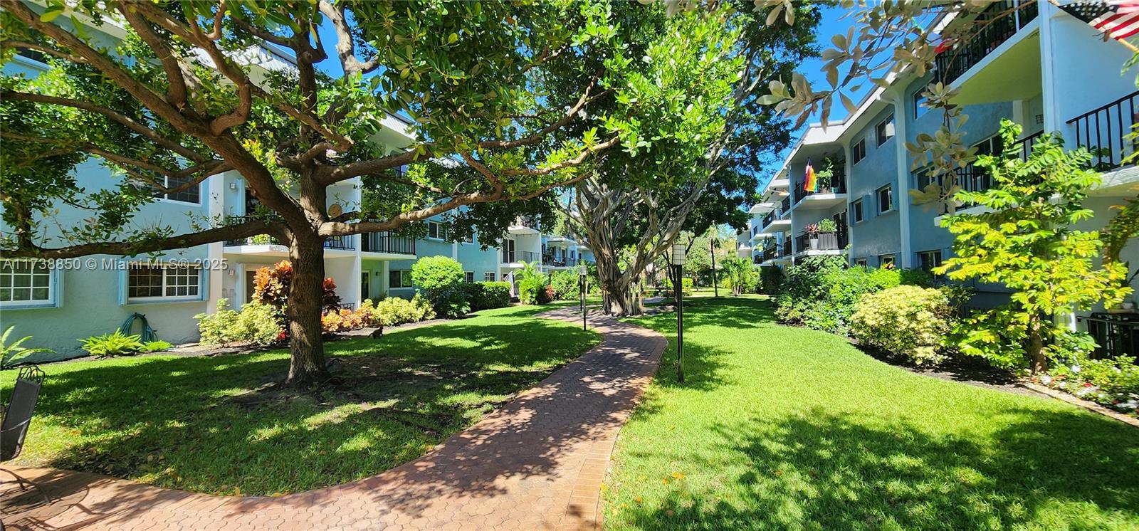 3004 Northeast 5th Terrace, Unit 214C Wilton Manors, FL 33334 - Photo 52 of 99 a view of a house with a tree in a yard