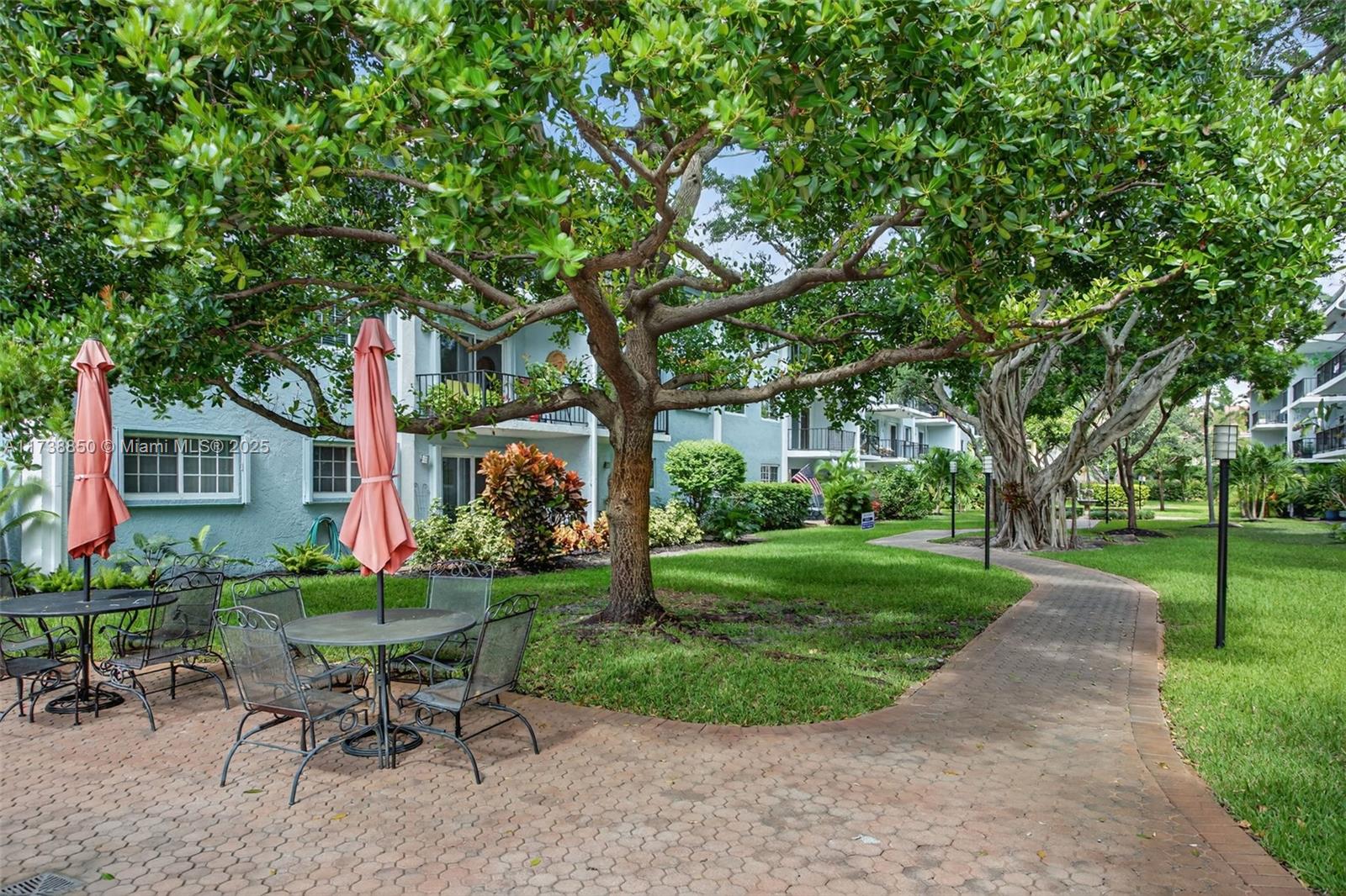 3004 Northeast 5th Terrace, Unit 214C Wilton Manors, FL 33334 - Photo 53 of 99 a view of a chair and table in backyard of the house