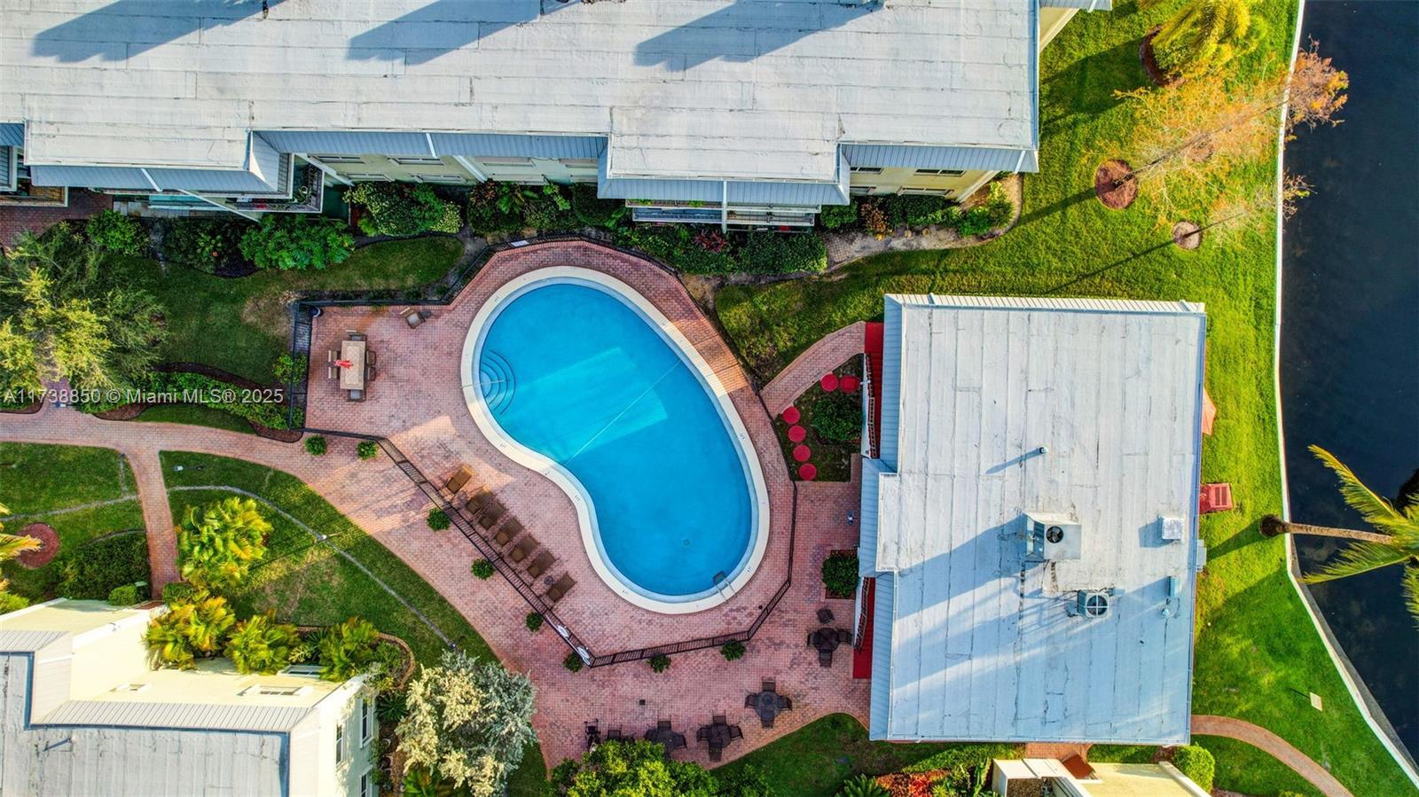 3004 Northeast 5th Terrace, Unit 214C Wilton Manors, FL 33334 - Photo 63 of 99 an aerial view of a house with swimming pool and garden