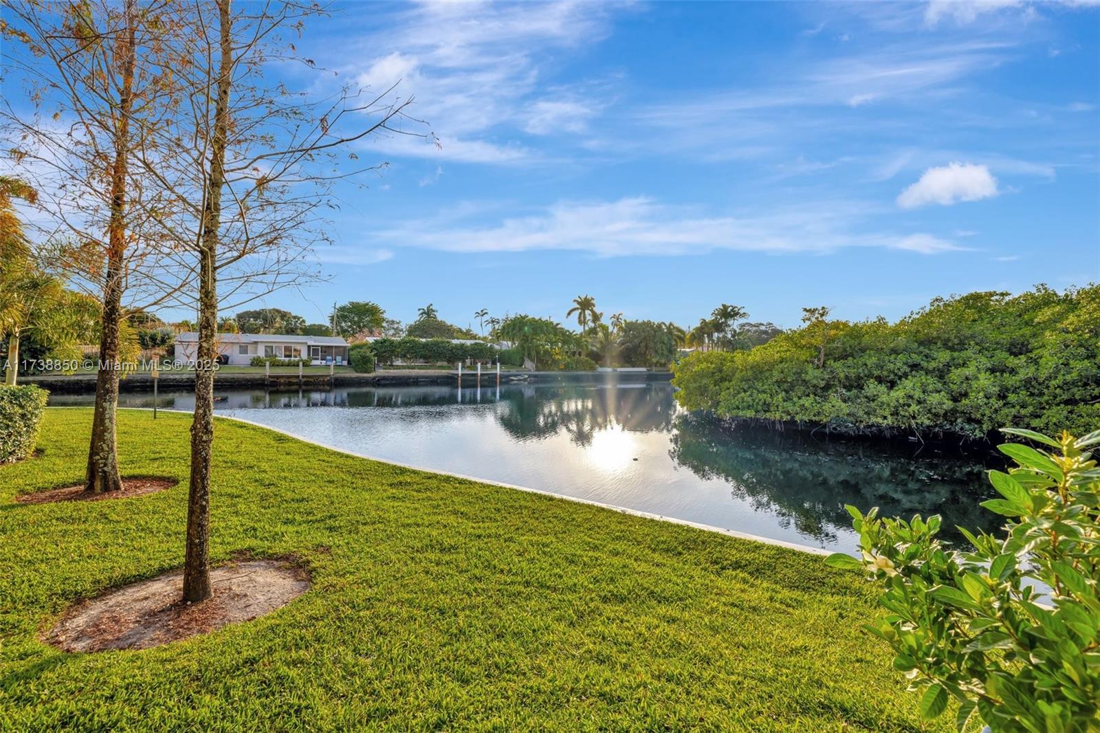 3004 Northeast 5th Terrace, Unit 214C Wilton Manors, FL 33334 - Photo 65 of 99 a view of a lake with houses in the back
