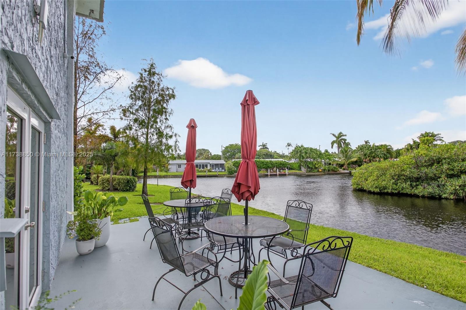 3004 Northeast 5th Terrace, Unit 214C Wilton Manors, FL 33334 - Photo 69 of 99 a view of a lake with a table and chairs