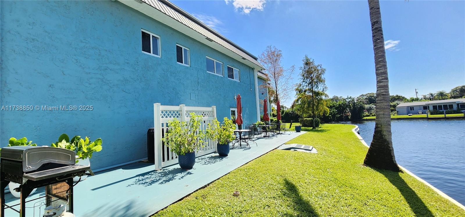 3004 Northeast 5th Terrace, Unit 214C Wilton Manors, FL 33334 - Photo 71 of 99 a swimming pool with outdoor seating and yard