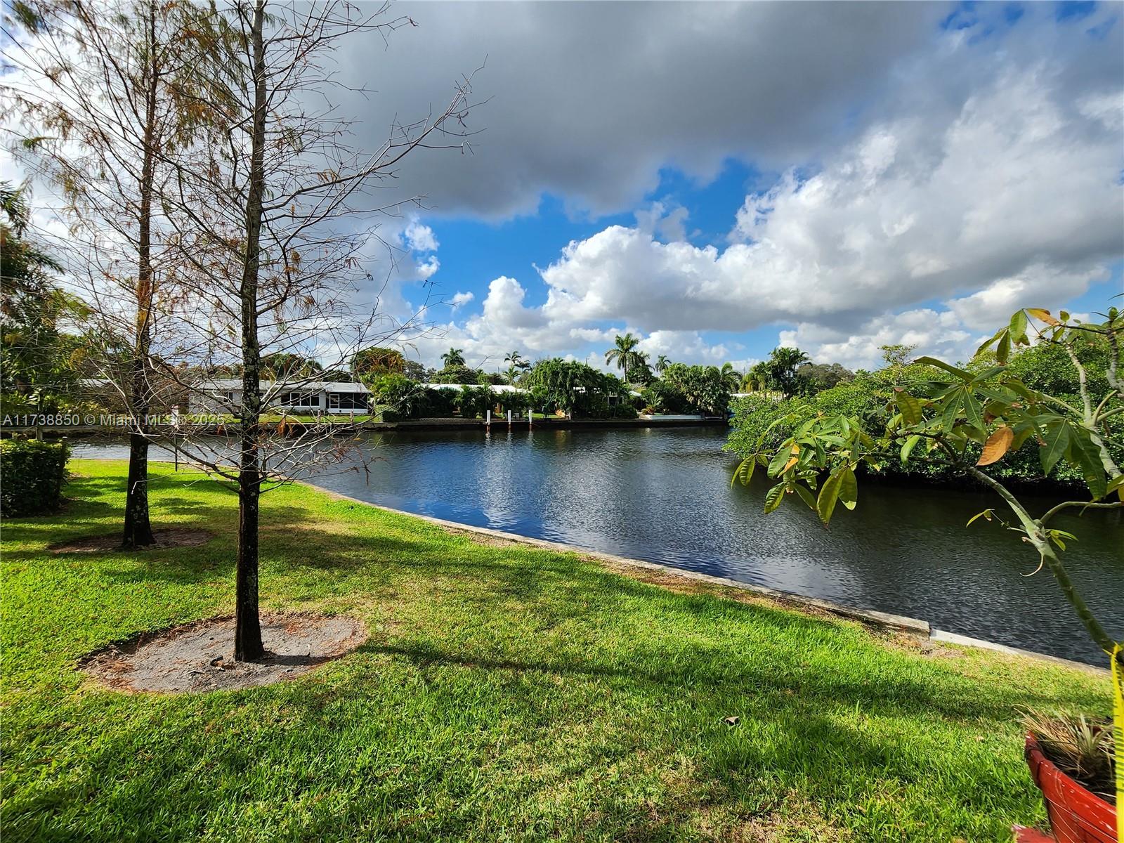 3004 Northeast 5th Terrace, Unit 214C Wilton Manors, FL 33334 - Photo 73 of 99 a view of a lake with houses in the back
