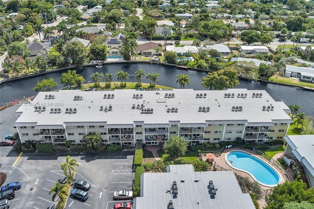 3004 Northeast 5th Terrace, Unit 214C Wilton Manors, FL 33334 - Photo 79 of 99 an aerial view of a house with a swimming pool