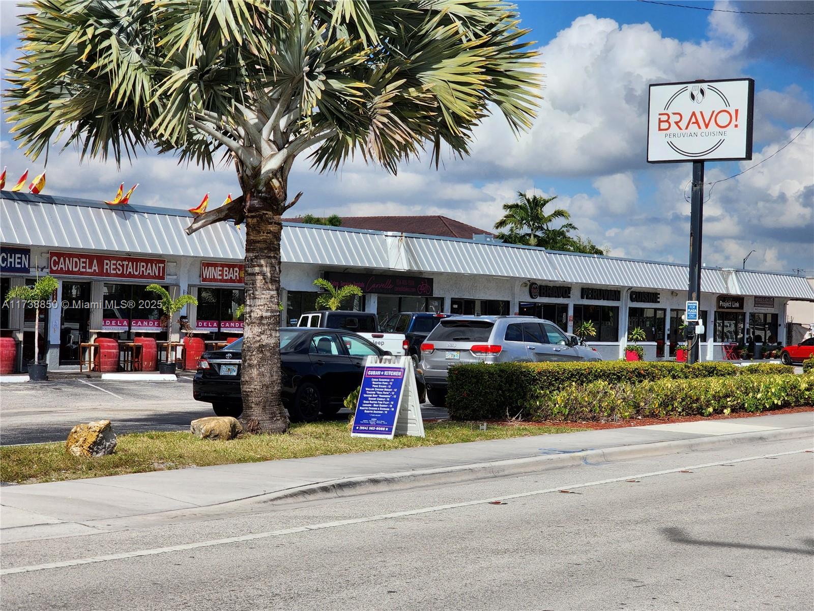 3004 Northeast 5th Terrace, Unit 214C Wilton Manors, FL 33334 - Photo 94 of 99 a view of a swimming pool with a lawn chairs and potted plants