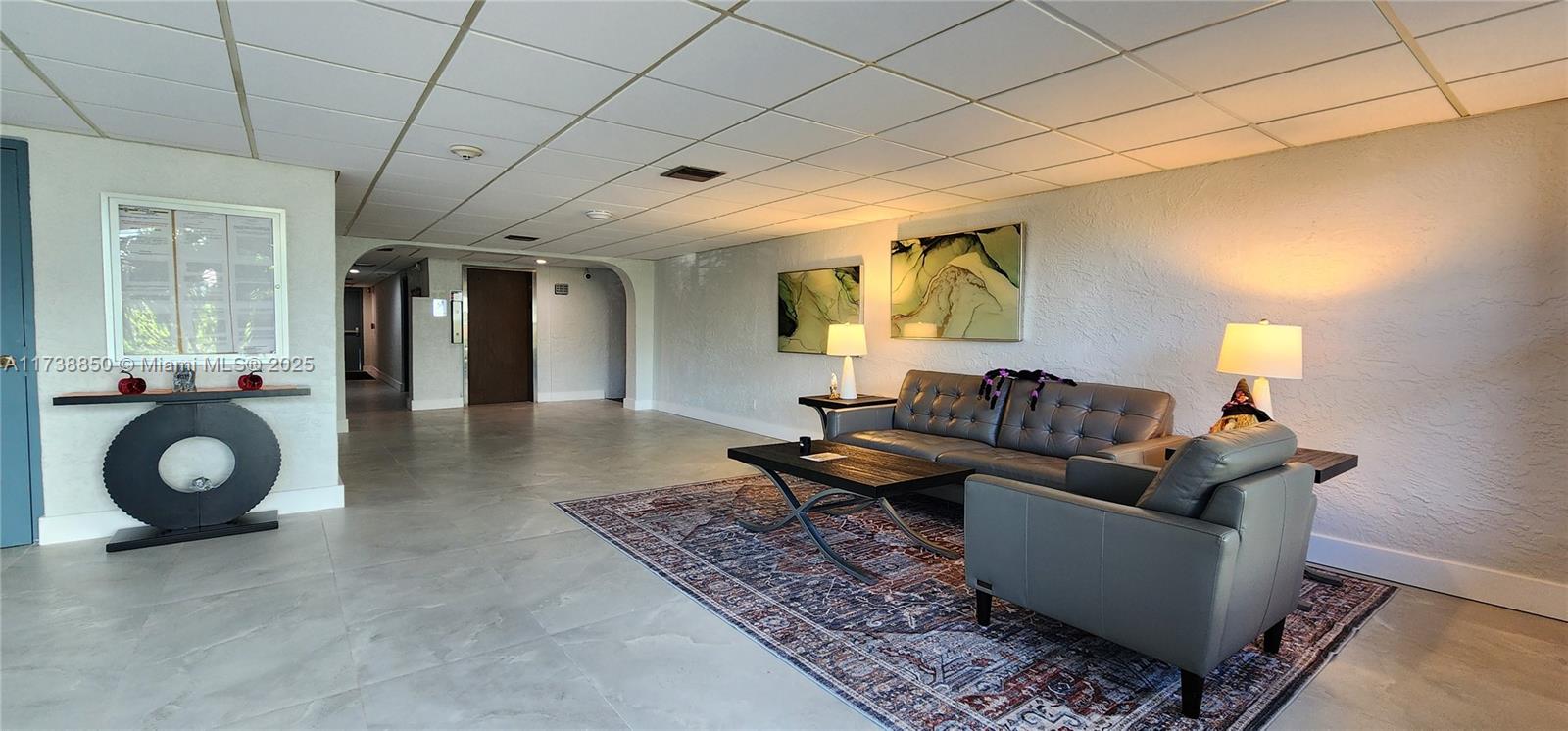 3004 Northeast 5th Terrace, Unit 214C Wilton Manors, FL 33334 - Photo 10 of 99 a living room with furniture and a wooden floor