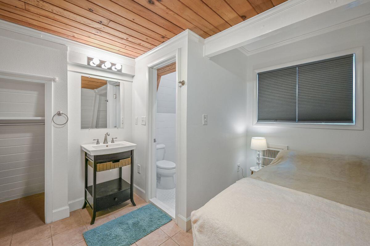 70 Dogwood Street Santa Rosa Beach, FL 32459 - Photo 10 of 15 a bathroom with a sink a mirror and a shower