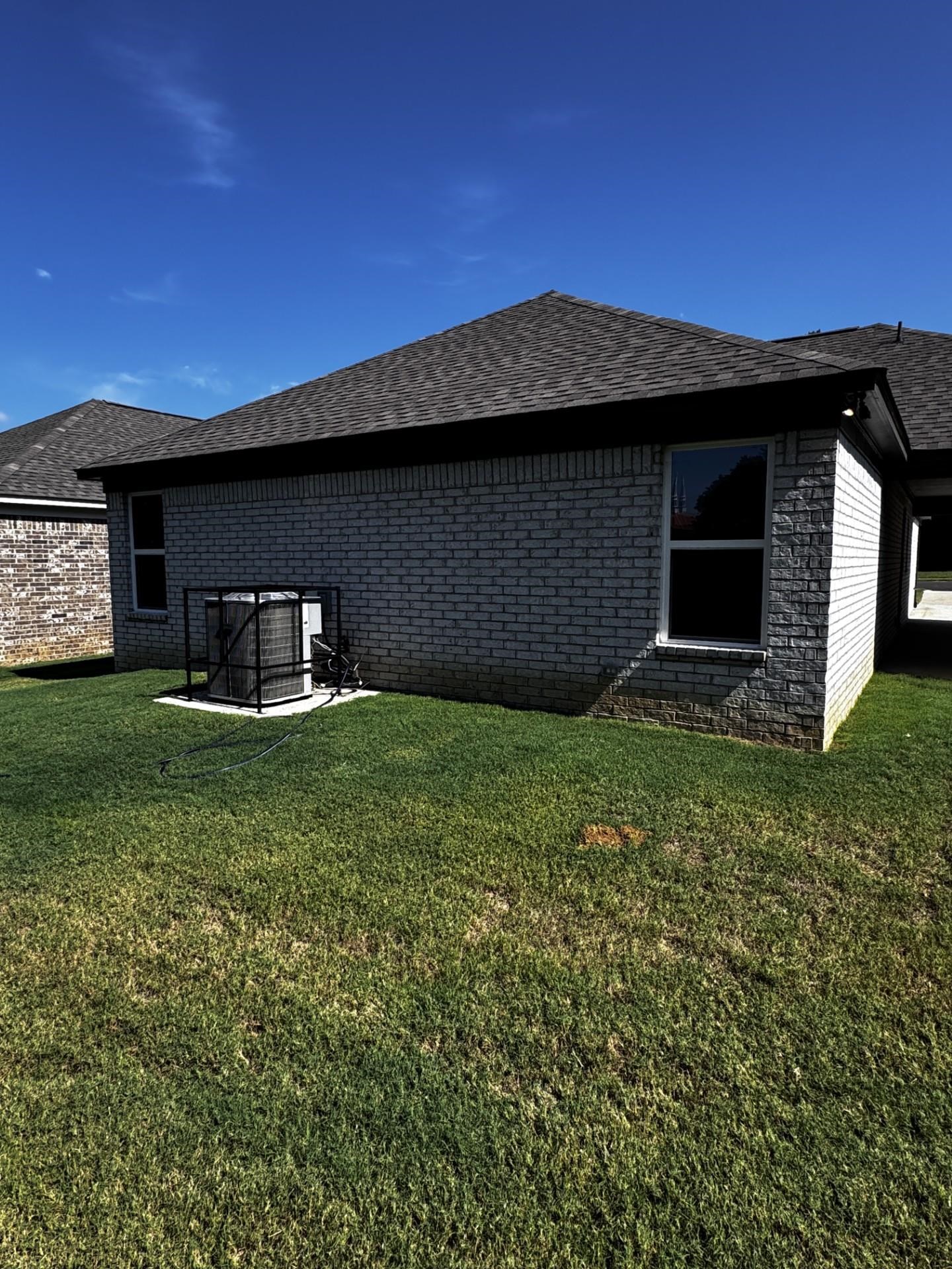 5263 Zodiac Road Memphis, TN 38118 - Photo 3 of 9 Back of property featuring a shingled roof, a yard, and brick siding