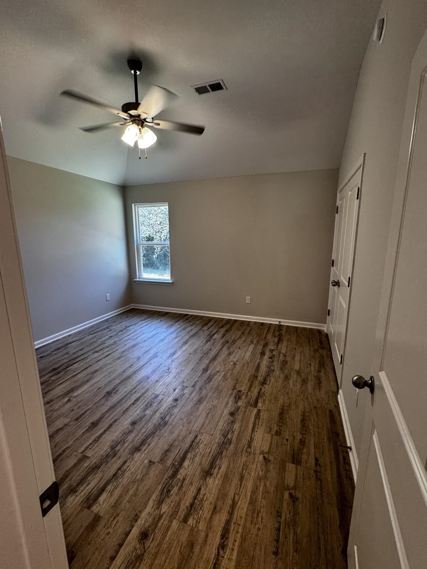 5263 Zodiac Road Memphis, TN 38118 - Photo 5 of 9 Spare room featuring dark wood finished floors and a ceiling fan