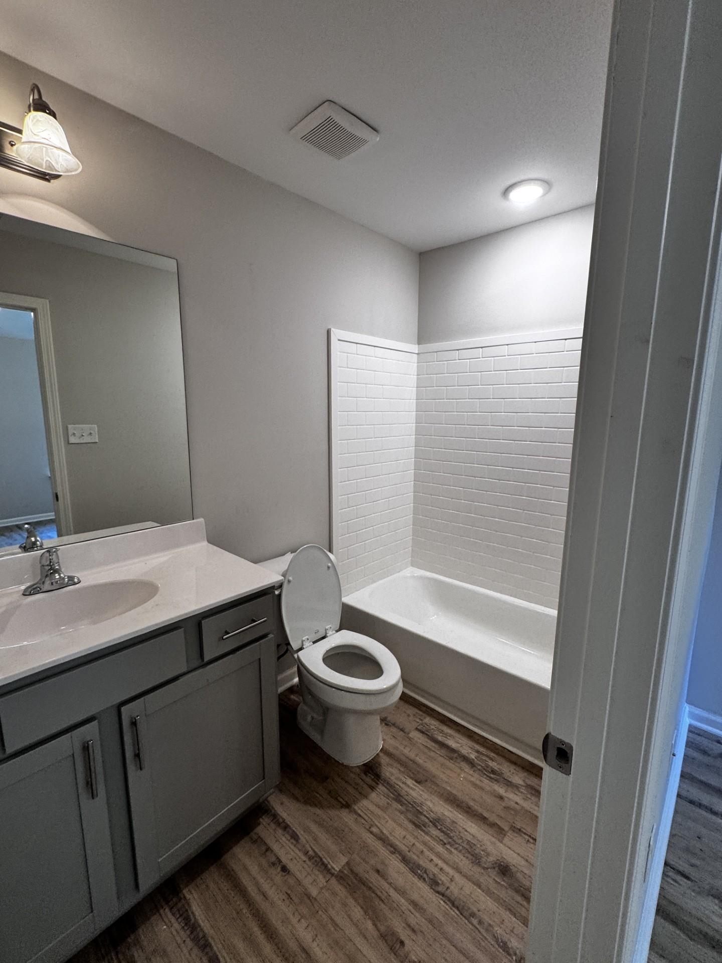 5263 Zodiac Road Memphis, TN 38118 - Photo 8 of 9 Bathroom with vanity, dark wood-type flooring, and shower / tub combination