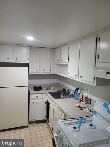 a kitchen with a sink a stove and refrigerator