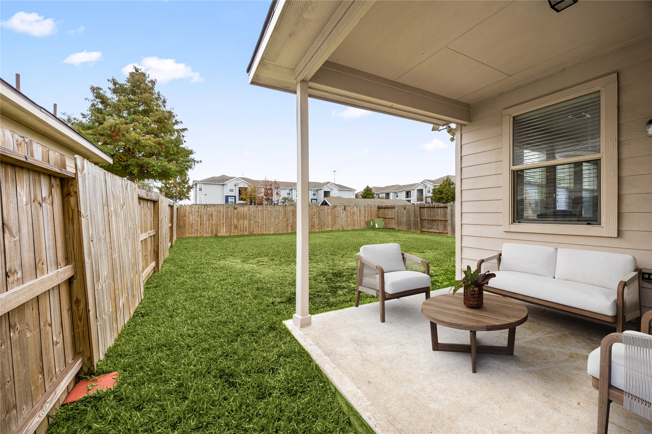 3526 Canvasback Lane Houston, TX 77047 - Photo 19 of 22 Enjoy outdoor living under the covered back patio, featuring a concrete slab and a peaceful view of the fenced backyard perfect for relaxing or entertaining. *Virtually Staged