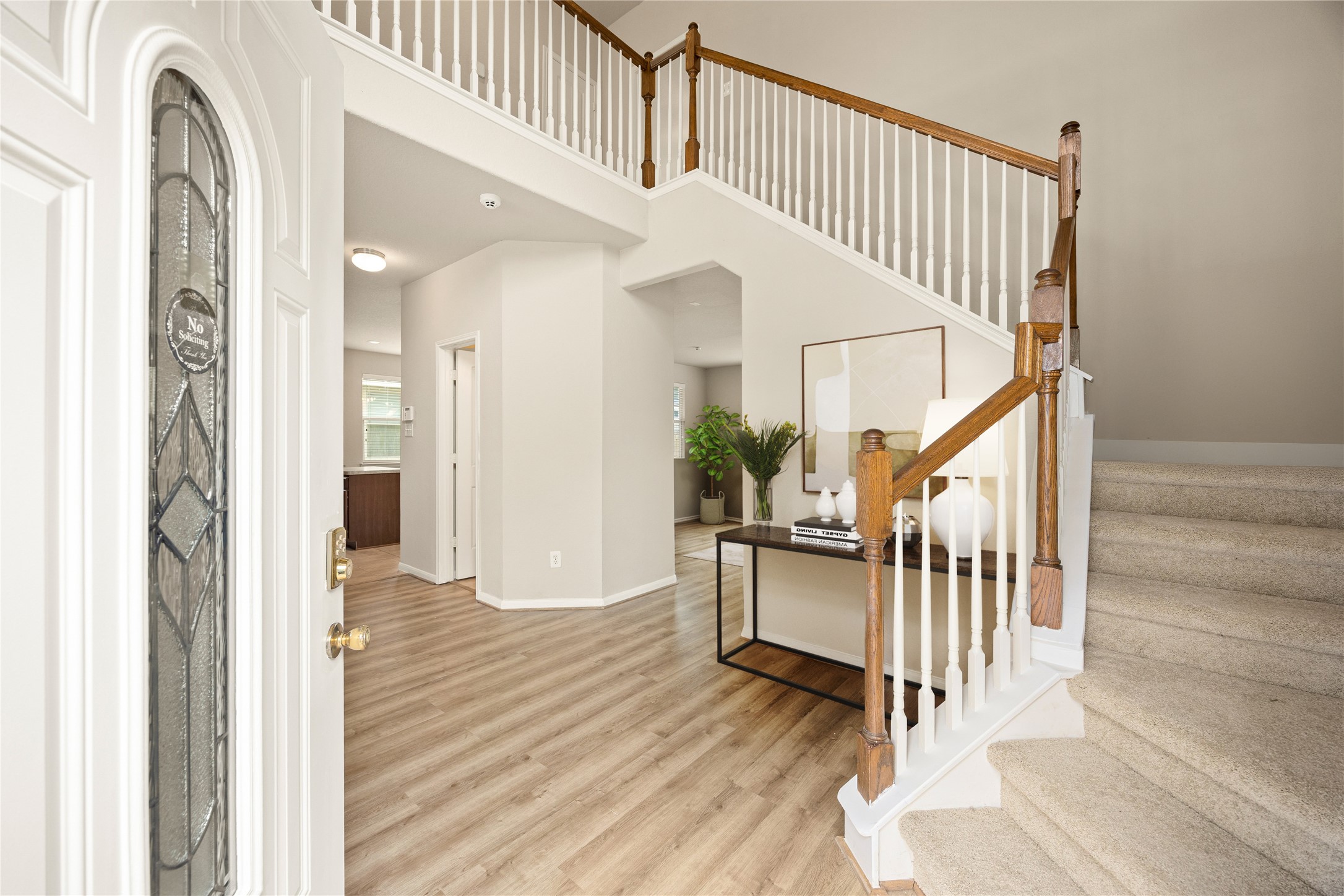 3526 Canvasback Lane Houston, TX 77047 - Photo 4 of 22 Upon entry, you’re welcomed by a bright and inviting foyer featuring neutral paint tones, wood-look flooring, high ceilings, and elegant staircase detailing. The open sightlines and natural light create an airy first impression, setting the tone for the rest of the home. *Virtually Staged